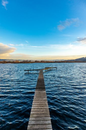 A vertical shot of a wooden dock in Werratal, Breitungen