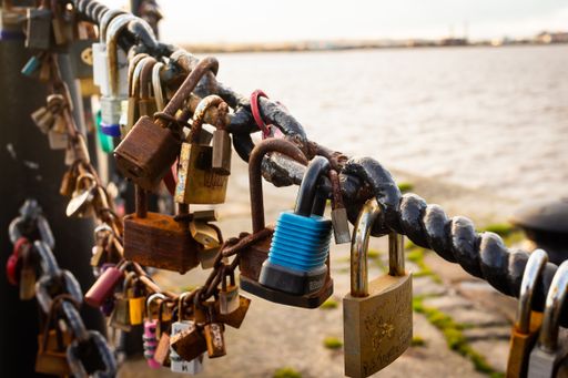 A beautiful shot of "Love Rocks"  on a metallic fence near the water in Liverpool