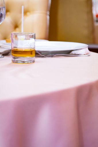 A vertical shot of a glass of beer on the table
