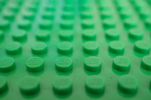 Close up of a green plastic Lego surface in soft focus.