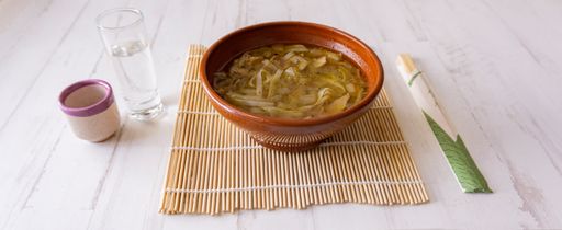 A high angle shot of a Japanese shoop with chopsticks on a white wooden background
