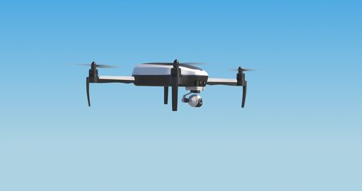 A close-up shot of a drone flying on blue sky in bright sunlight