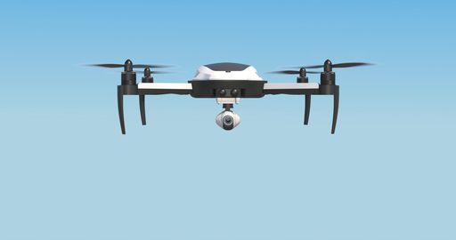 A low angle shot of a drone flying on blue sky in bright sunlight