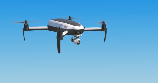 A low angle shot of a drone flying on blue sky in bright sunlight