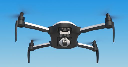 A low angle shot of a drone flying on blue sky in bright sunlight