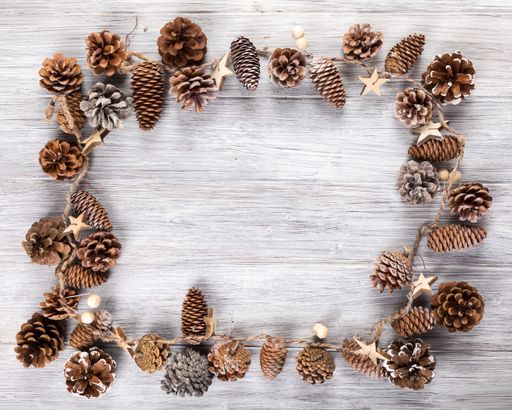 A flat lay of a rustic Christmas string decor forming a frame with copy space