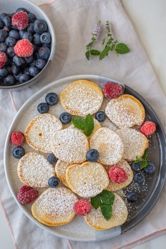 A vertical top view of homemade fluffy pancakes on the table