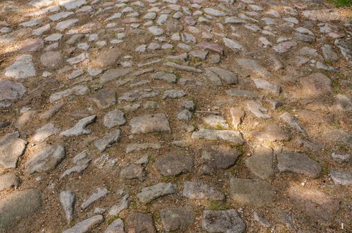 A landscape shot of brown stone textured floor outdoors