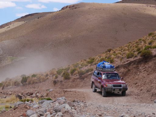 A closeup of a Toyota land cruise in a desert