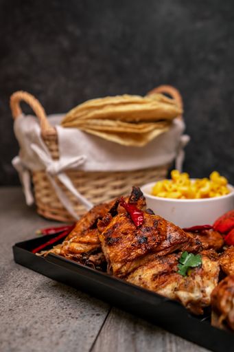A pieces of grilled chicken with fries