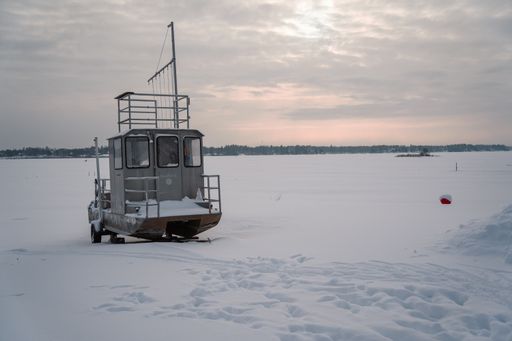 A closeup shot of a small boat in a frozen lake in Jarvenpaa, Finland