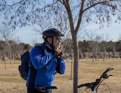 A side view of a mid-aged cyclist with helmet and sunglasses outdoors in Spain