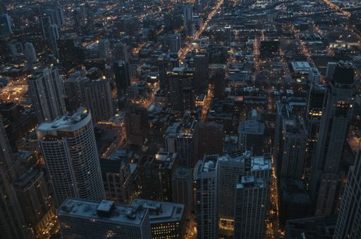 An aerial shot of skyscrapers in the city of Chicago during nighttime