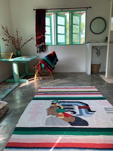 A vertical shot of the interiors of a house including the table, chair, and carpet