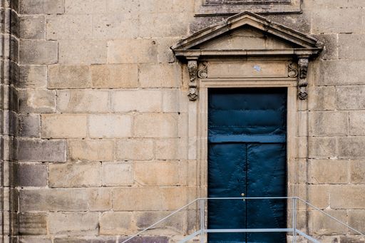 A closeup shot of the entrance of an old building made of rectangular stones