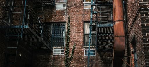 A horizontal shot of fire escape stairs on a brick building
