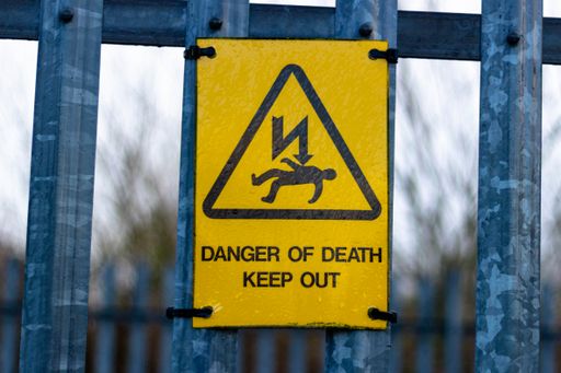 A close-up shot of a sign "Danger of death Keep out"