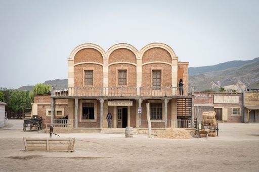A Wild west movie set with some men fighting in a gunfight
