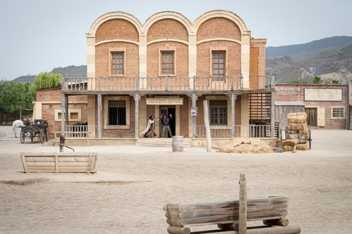 A Wild west movie set with some men fighting in a gunfight