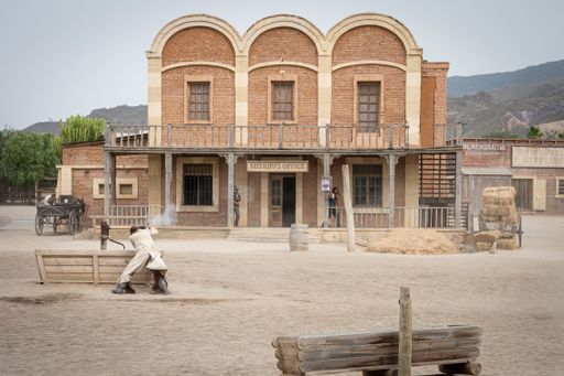 A Wild west movie set with some men fighting in a gunfight