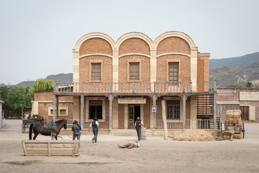A Wild west movie set with some men fighting in a gunfight