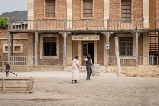 A Wild west movie set with some men fighting in a gunfight