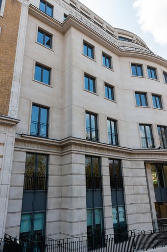 A low angle shot of the modern building with glass windows in London