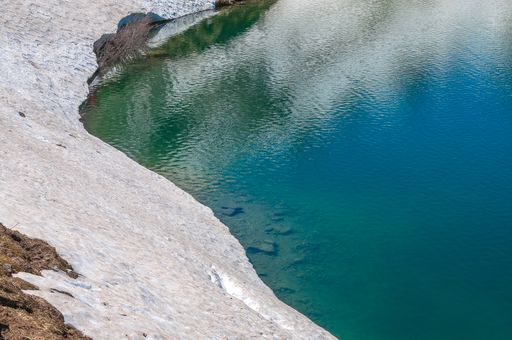 A closeup of the lake Lac Lioson surrounded by snow in Switzerland