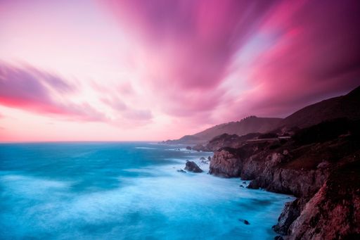 An aerial aesthetic scenic view of the sea with the breathtaking purple sky above