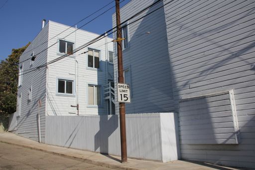 A view of a a small street near white building