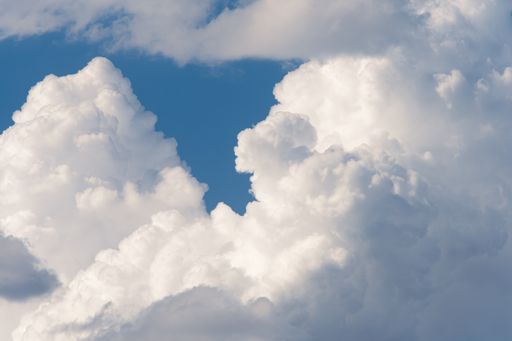 A beautiful view of a celestial sky with white clouds on a sunny day
