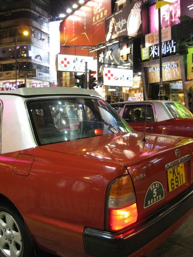 hong kong taxis in busy shopping street at night, hong kong, china