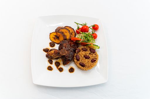 A top view of a meal with rice, meat, banana, and vegetables isolated on a white background