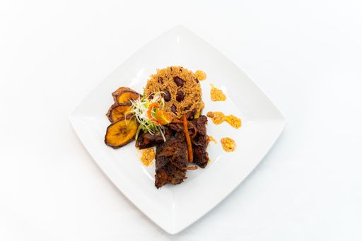A meal with rice, meat, banana, and vegetables isolated on a white background