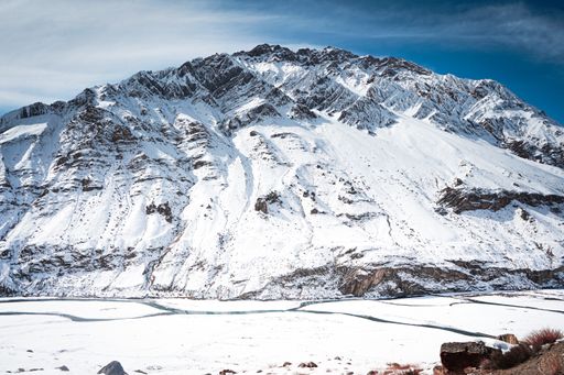 The mountains covered in snow with the blue sky in the background in Spiti valley