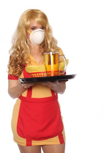 A beautiful shot of a restaurant and bar waitress wearing n95 mask to prevent illness