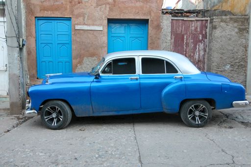 A blue retro car parked in the street in Trinidad, Cuba