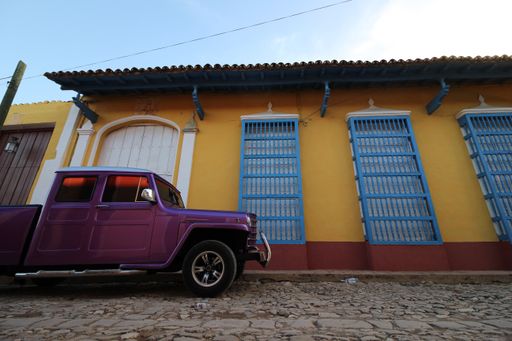 A beautiful view of a parked car on the street in Trinidad under the blue sky