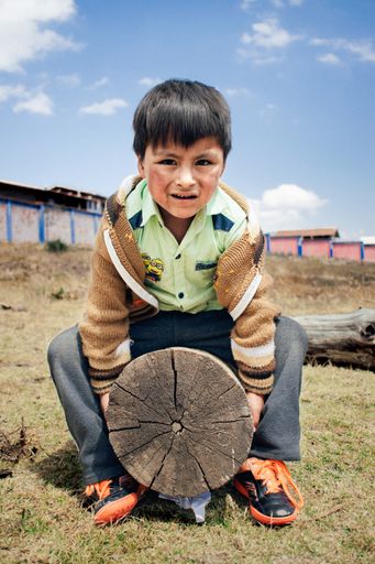 Niño en pobreza en el interior del Perú , mirando una cámara  por primera vez
