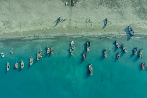 A top view of boats on a blue seashore