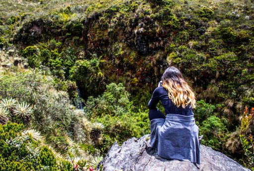 A high angle shot of a female shooting of the beautiful green landscape