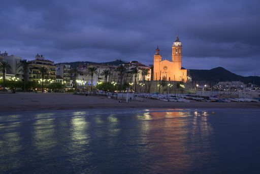 Sitges parish church illuminated at night near the beach