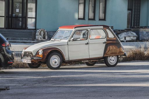 A vintage Citroen Dyane parked on the street classical oldimer car from 1970's.