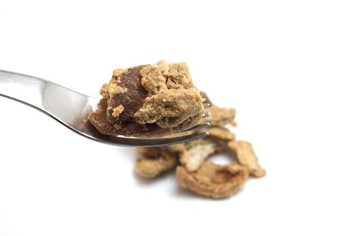 A closeup shot of small pieces of roasted pork isolated on white background