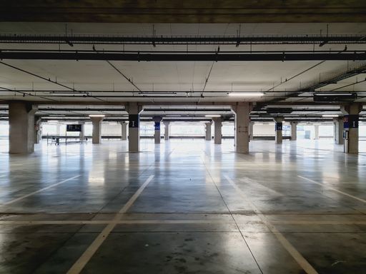 An empty and illuminated parking place at the mall.