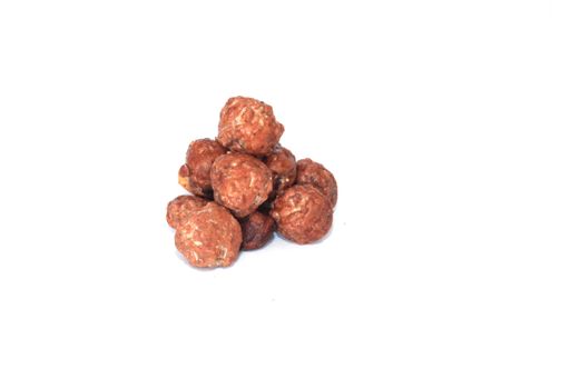 A closeup shot of butter-toasted peanuts isolated on white background
