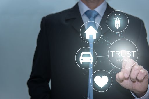 Businessman touching trust icon. Life, house, car and motorcicle insurance. Family protection concept.