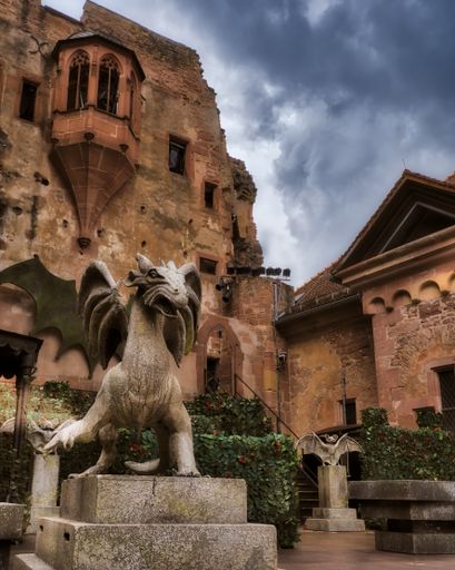 The ruins of an old historic Heidelberg castle amid dense greenery on a gloomy day in Germany