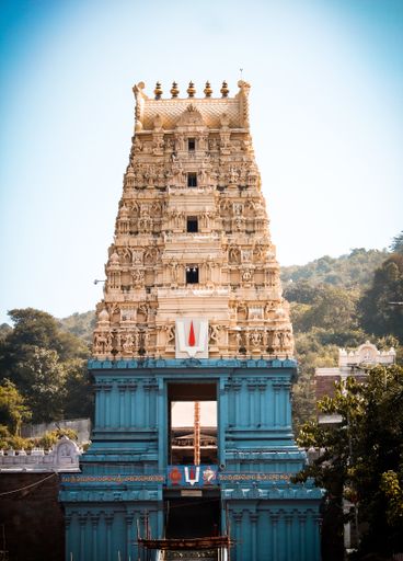 A beautiful shot of Sri Varahalakshmi Narasimha Swamy Vari Devasthanam against blue sky in bright sunlight in Visakhapatnam, Andhra Pradesh, India