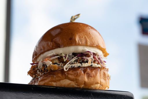 A soft focus of a mouthwatering hamburger with wooden skewer against a bright background